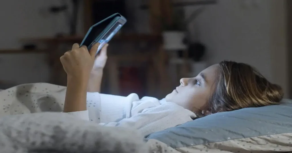child browsing social media while lying on bed